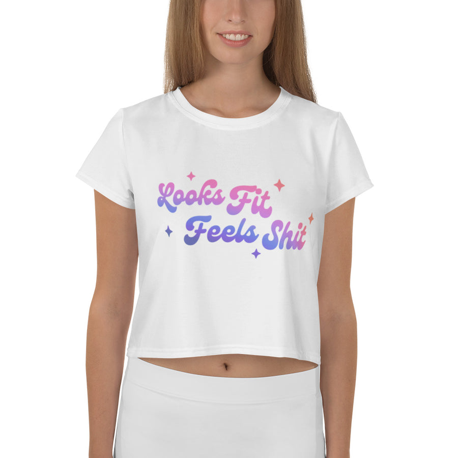 crop white tee with "looks fit feels shit" printed on the front in a purple to pink gradient, worn by model