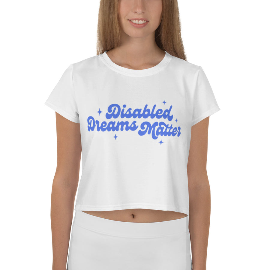 white crop tee with "disabled dreams matter" printed in blue on the front, worn by model
